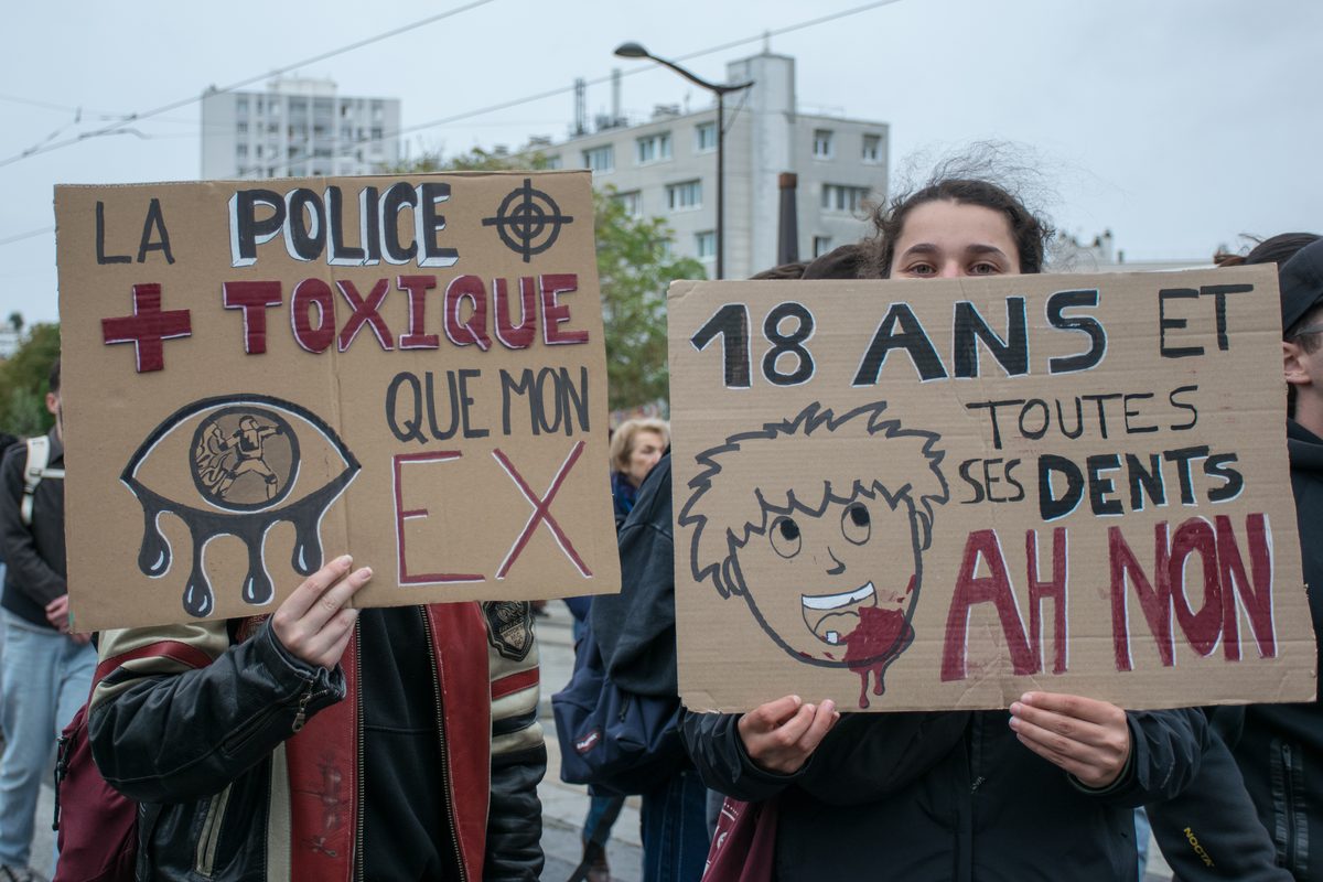 Young demonstrators hold signs in Paris, 24 October 2026