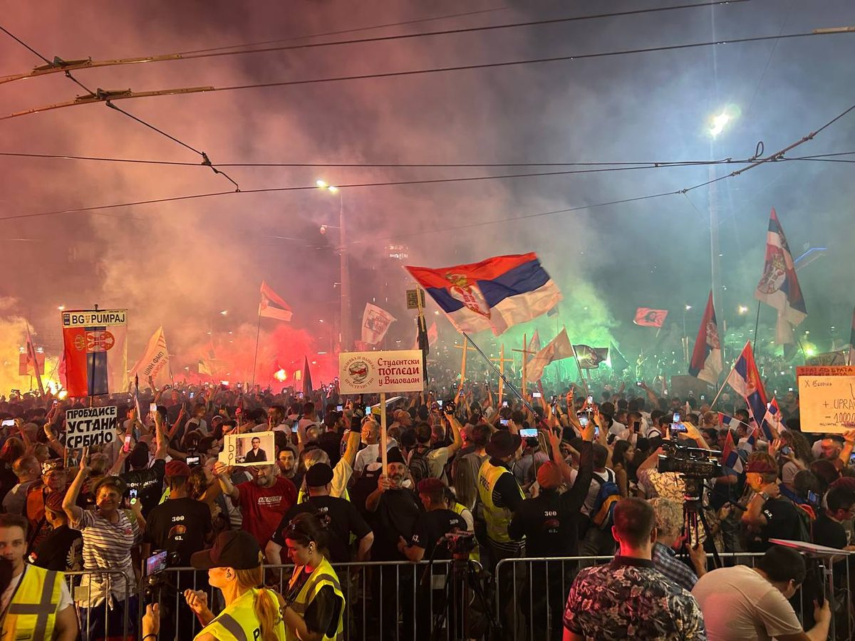 Students and citizens protest at Slavija Square in Belgrade at night, 28 June 2025, with Serbian flags and student signs
