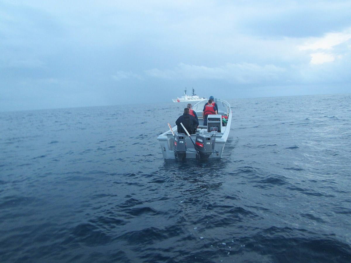 Coast Guardsmen from Cutter Sherman search a suspected drug smuggling vessel after a three-hour chase 270 miles south of Guatemala in the Eastern Pacific Ocean, July 2016